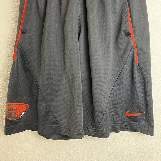 Front view of Oregon State team-issued Nike Dri-FIT gray basketball shorts with orange accents.