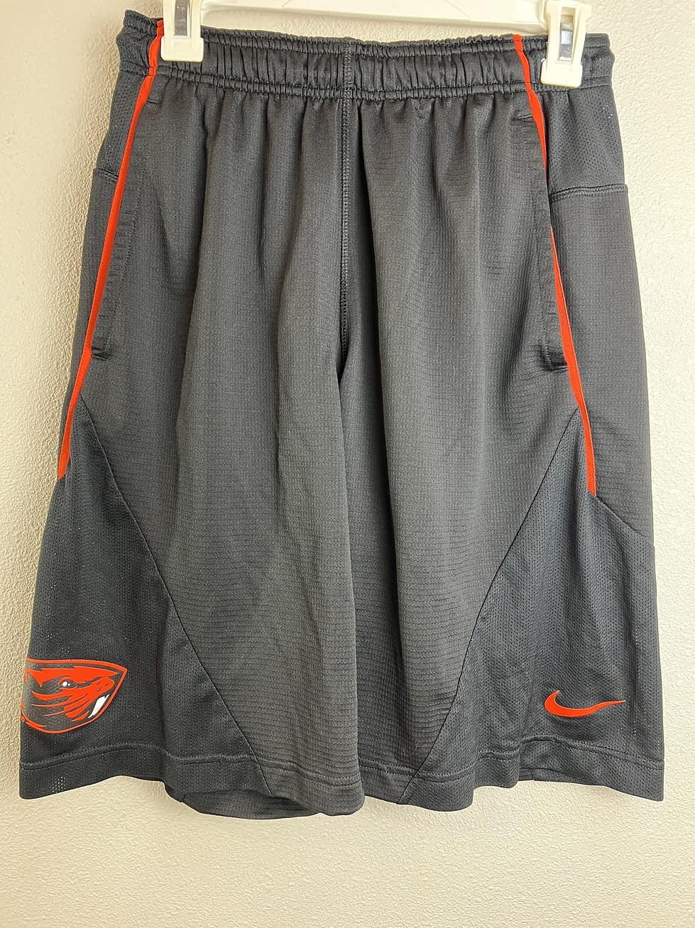 Front view of Oregon State team-issued Nike Dri-FIT gray basketball shorts with orange accents.