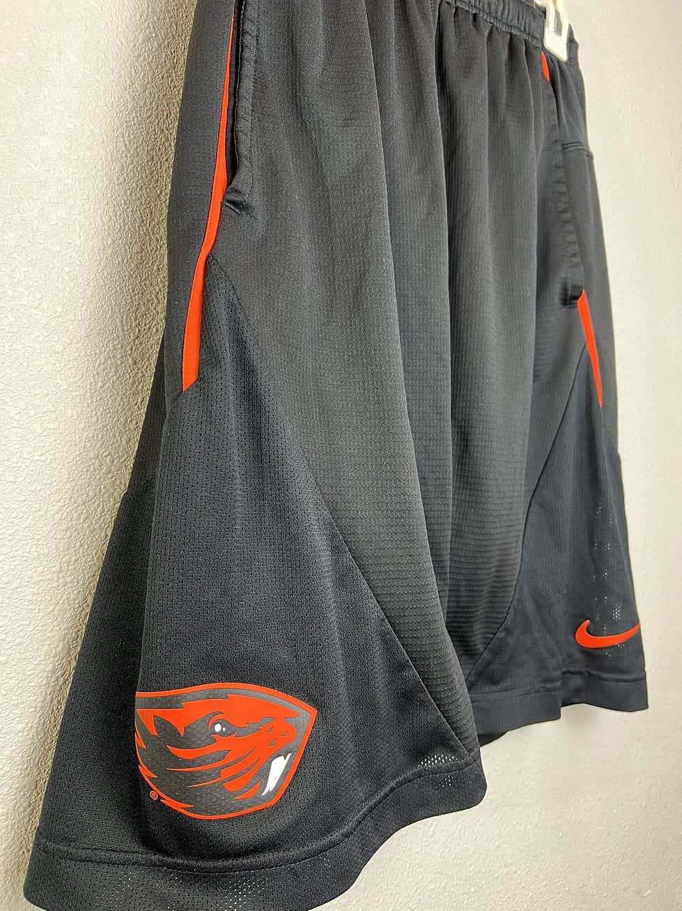 Side view of Oregon State Nike basketball shorts showing Beavers logo and orange detailing.