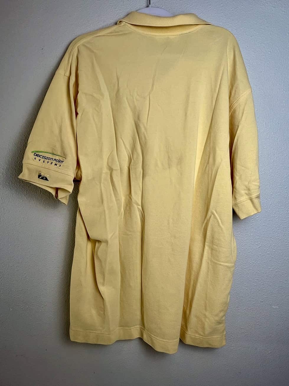Back view of pale yellow Oregon Ducks polo shirt.