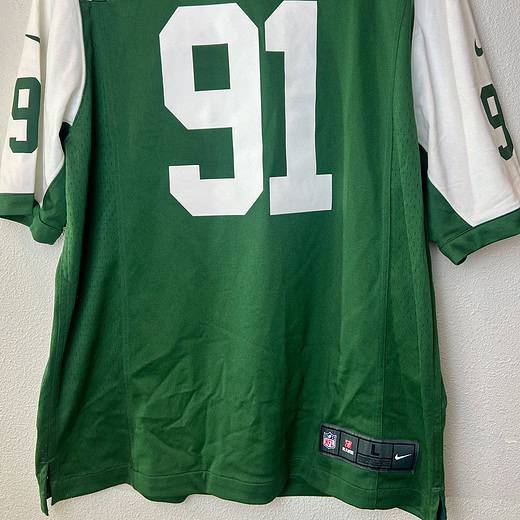 Front of NY Jets #91 jersey, green with white accents and NFL patch.