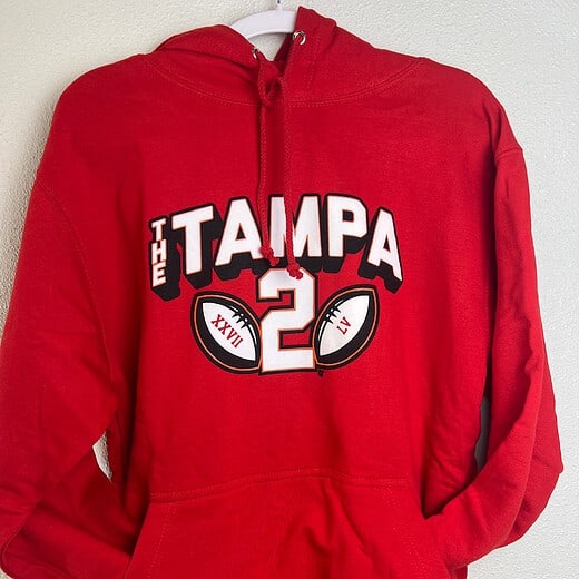 Front view of red BreakingT ‘Tampa 2’ hoodie, size small, with football graphics.