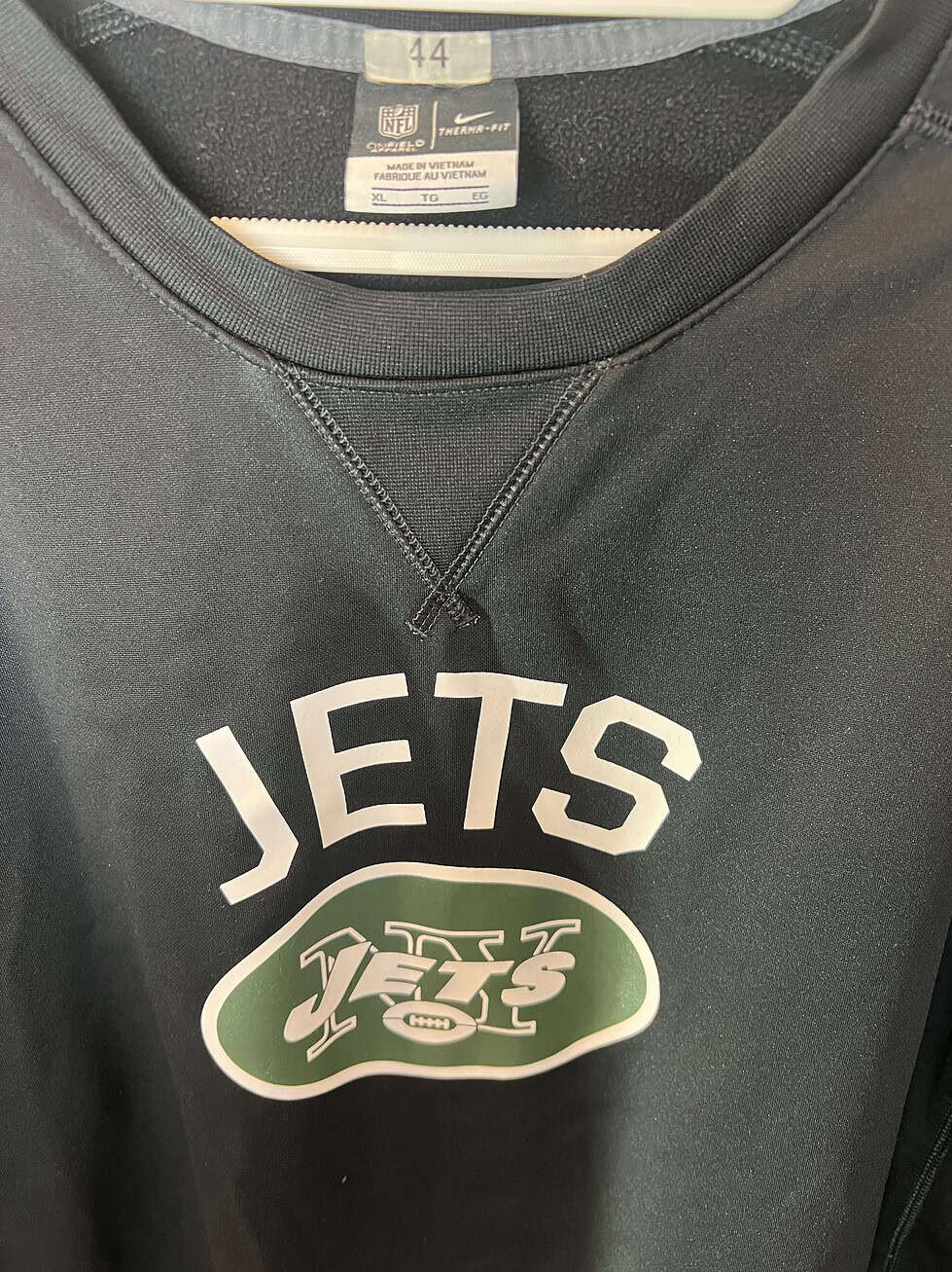 Close-up of Nike Therma-FIT tag and Jets chest logo for team-issued authenticity.