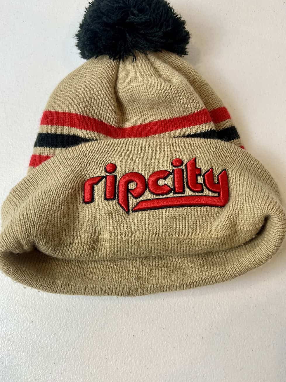 Side angle of Rip City beanie with retro stripe design showing little to no signs of wear.