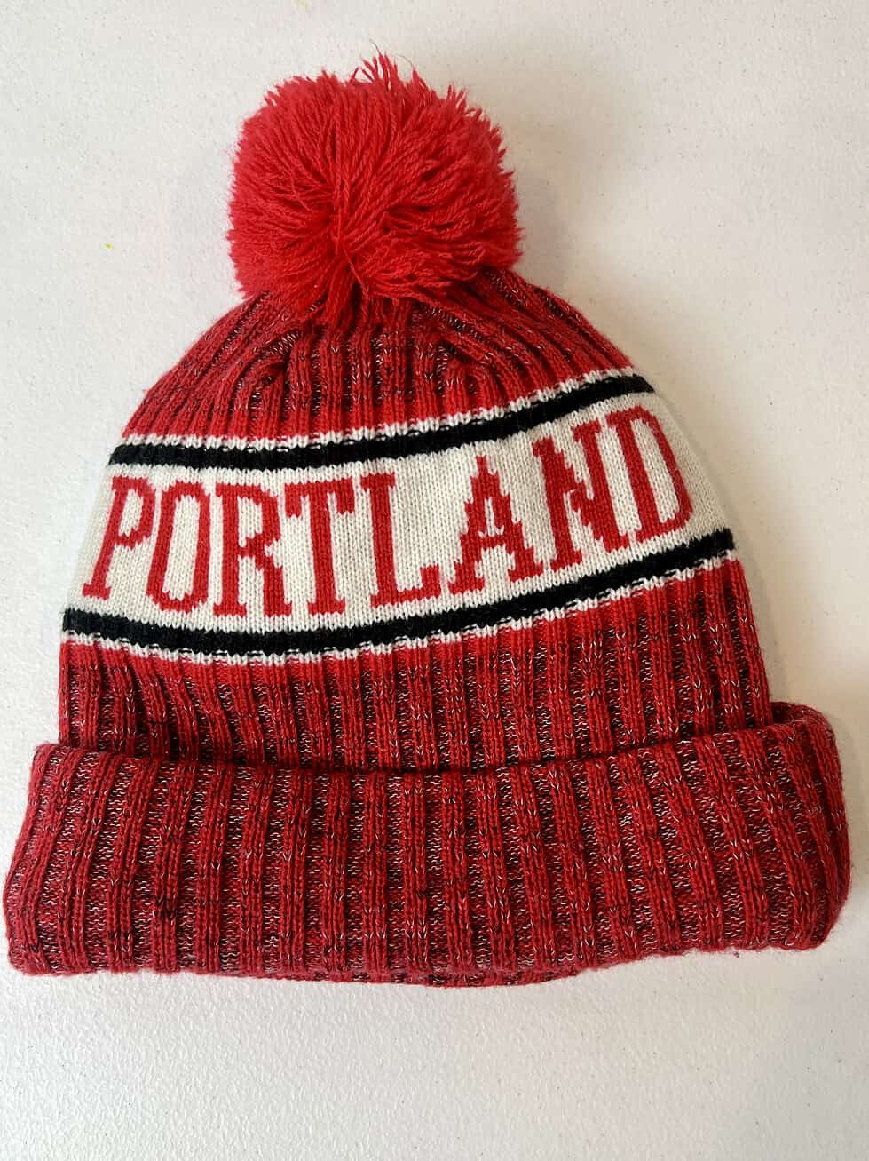 Side view of beanie with embroidered Trail Blazers logo and cuff detail.