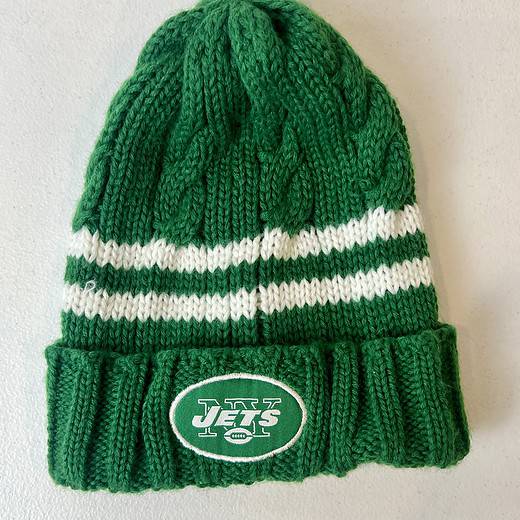 Green and white knit NY Jets kids beanie with striped design and cuffed logo.