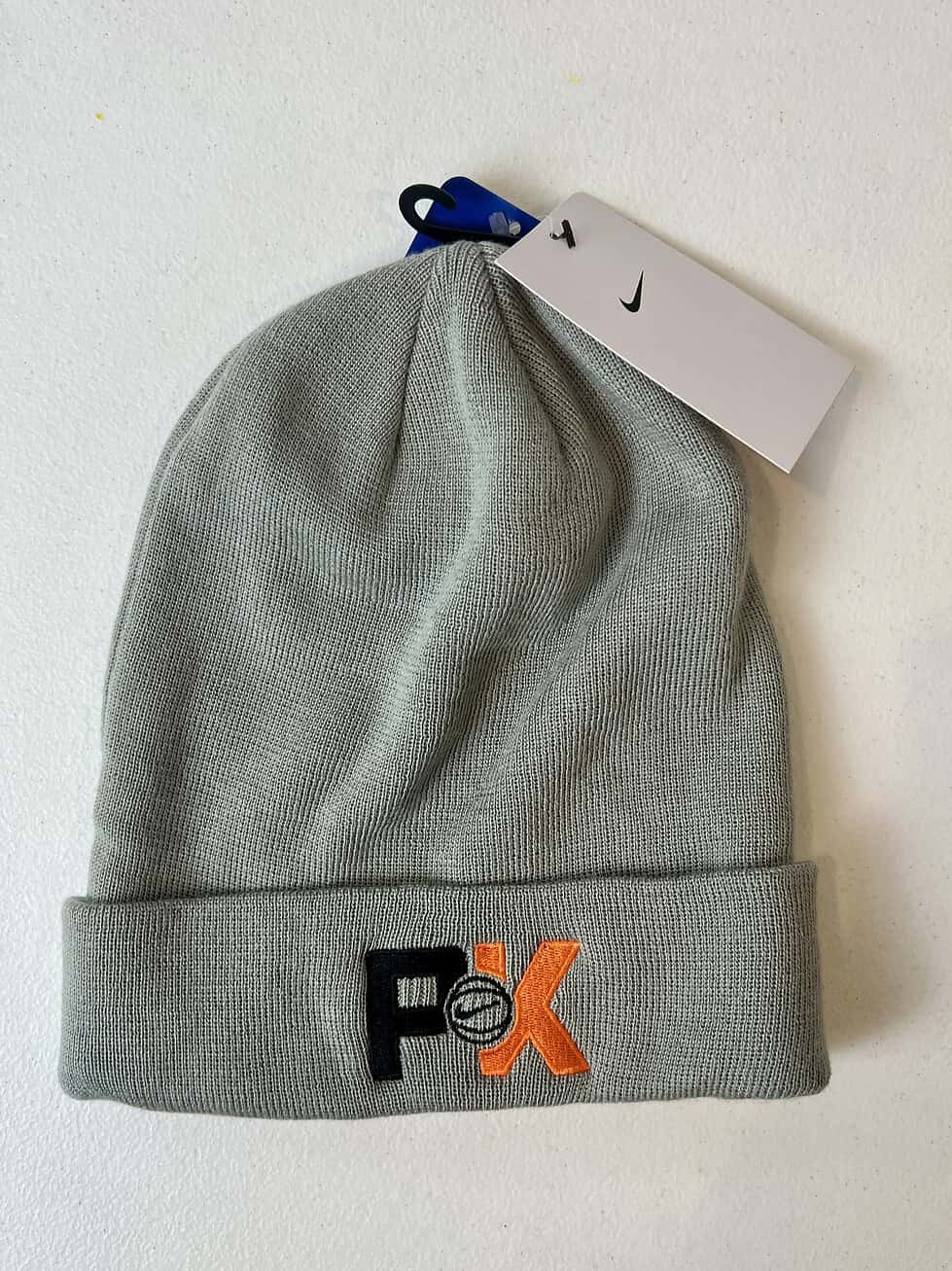Light gray Nike beanie with embroidered Swoosh and NBA-style tag.