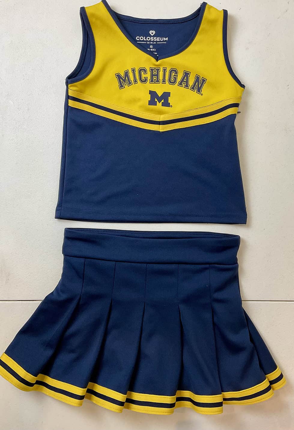Laid-flat view of Michigan Wolverines youth cheer uniform by Colosseum.