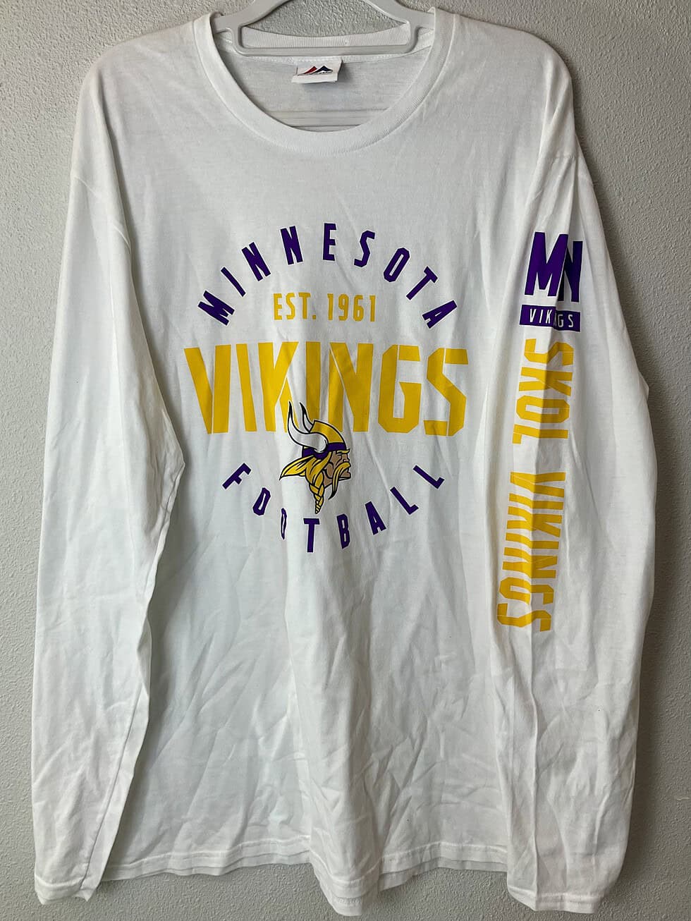 Front view of Minnesota Vikings long-sleeve Majestic shirt with bold graphics.