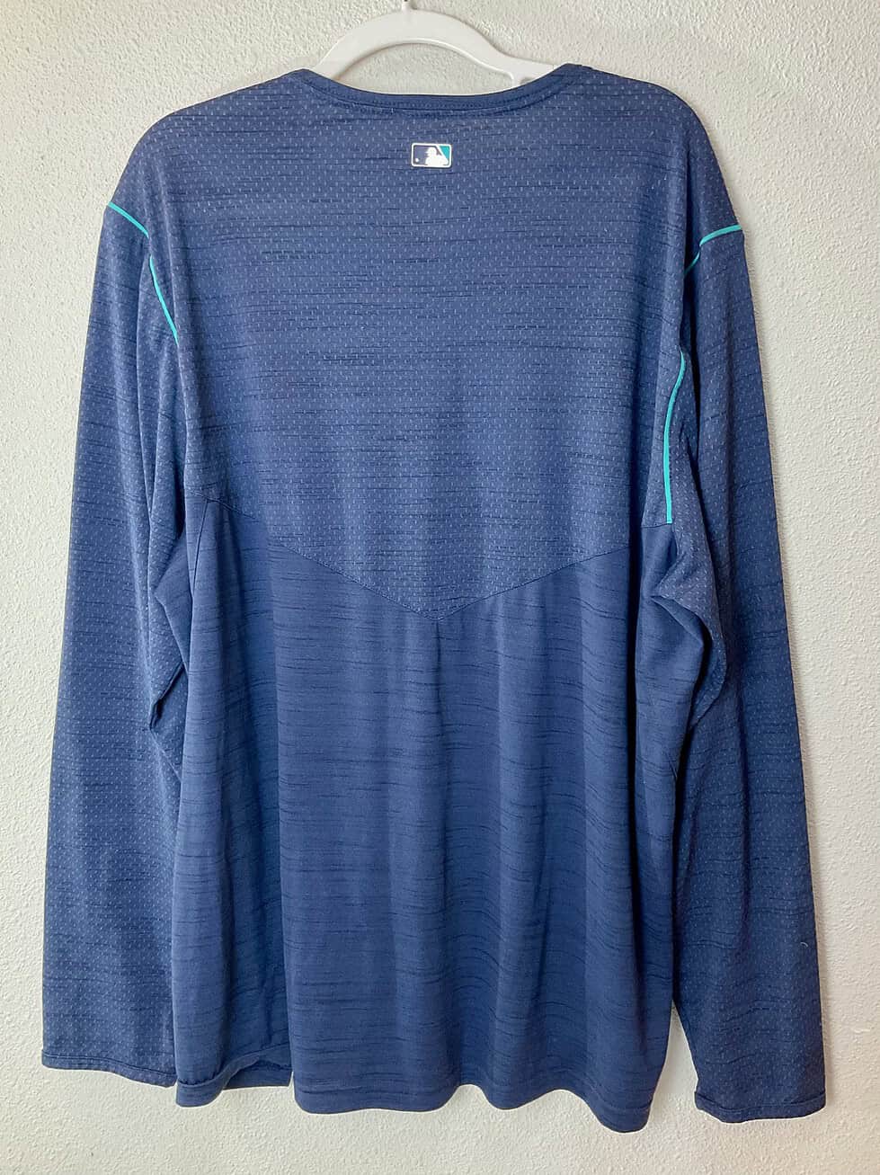 Back view of the Mariners Nike Dri-FIT pullover, featuring breathable mesh paneling