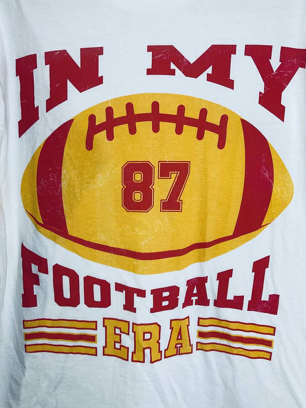 Close-up of bold red and gold football design with Travis Kelce’s number.