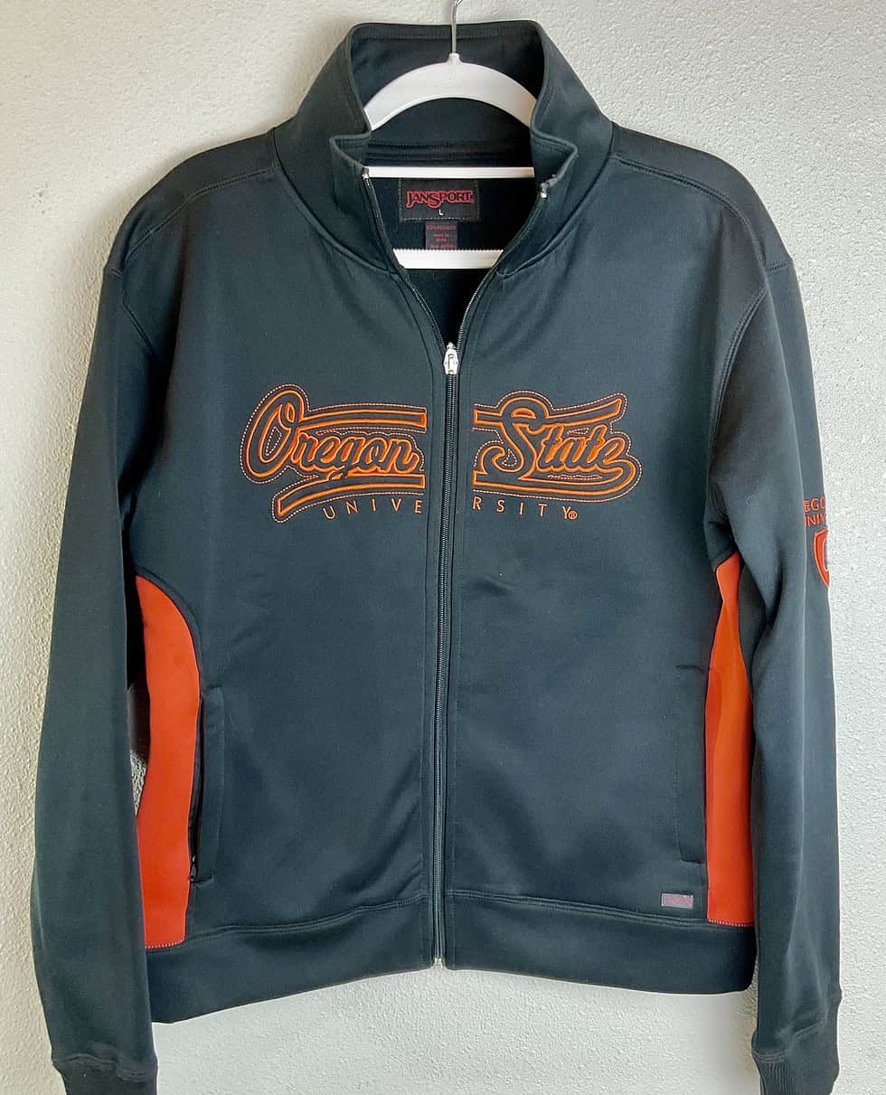Front view of black Oregon State Beavers full-zip jacket with orange embroidery.