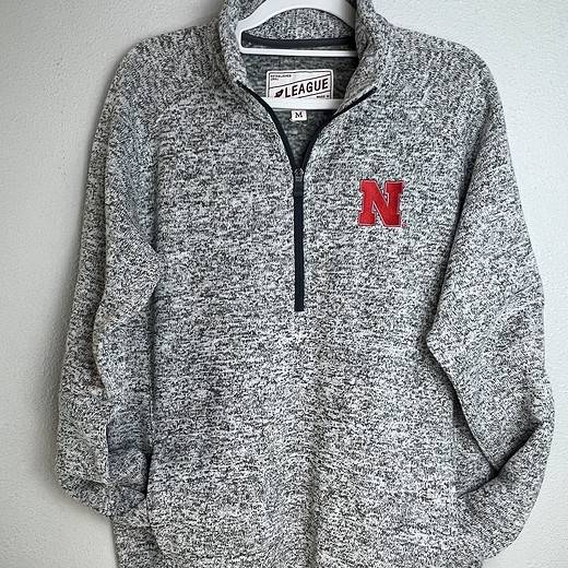 Heathered gray Nebraska Huskers quarter-zip pullover with red “N” logo on front.