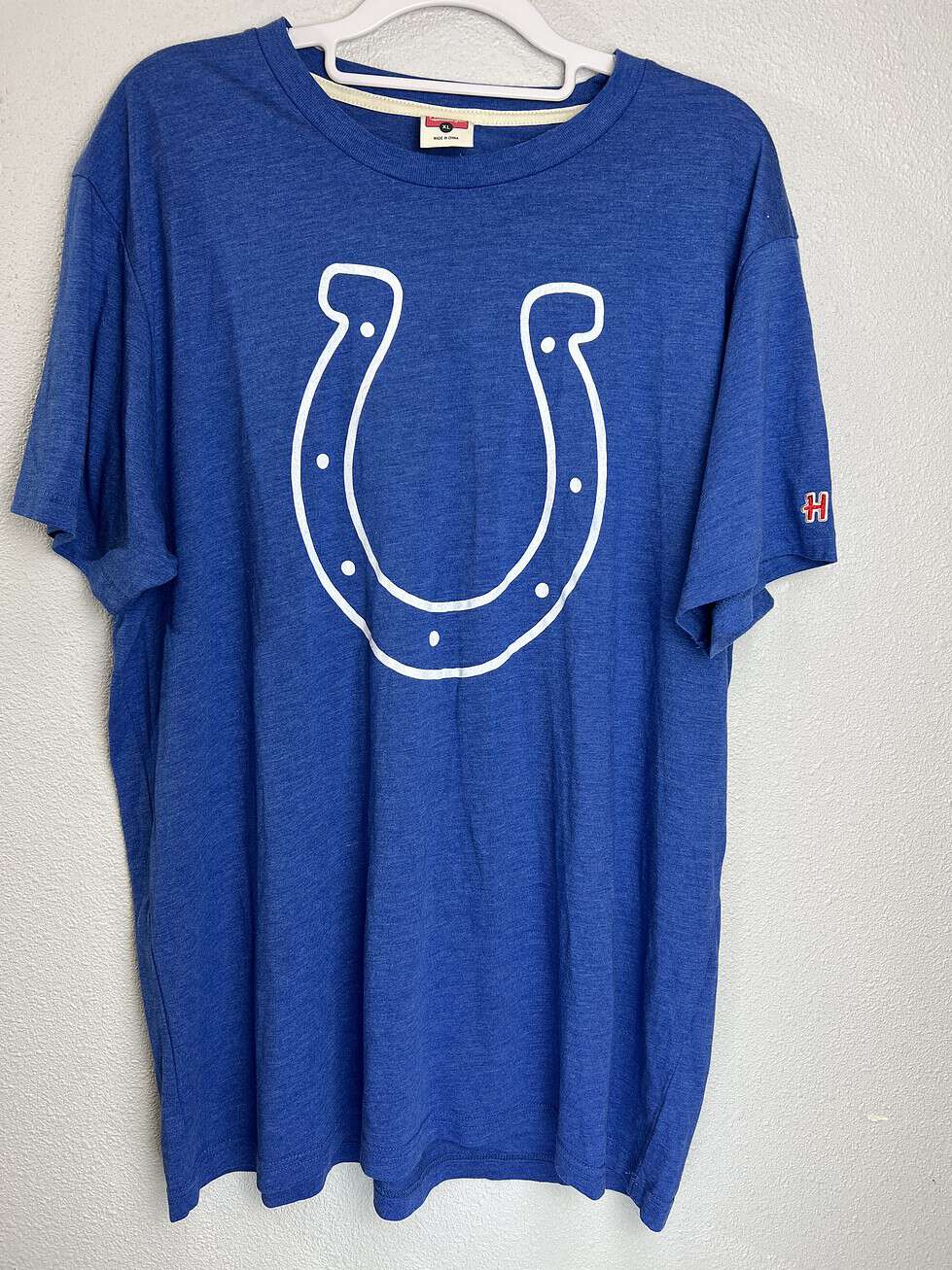 Blue Indianapolis Colts T-shirt with large white horseshoe logo on front.