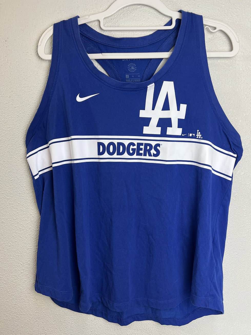 Blue LA Dodgers Nike Dri-FIT racerback tank top with white LA logo and Dodgers text.