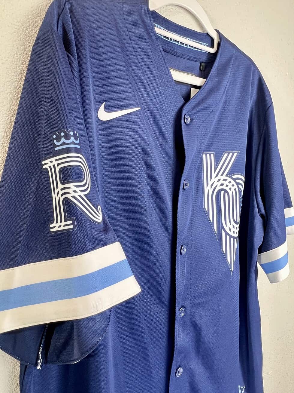 Full front view of KC Royals City Connect jersey with striped sleeve accents.