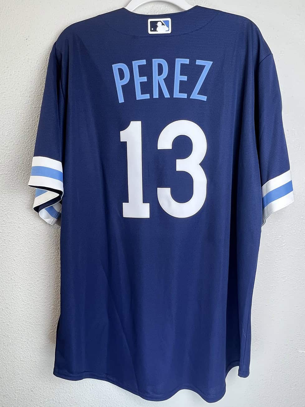 Back view of Salvador Perez #13 Royals City Connect jersey in navy blue.