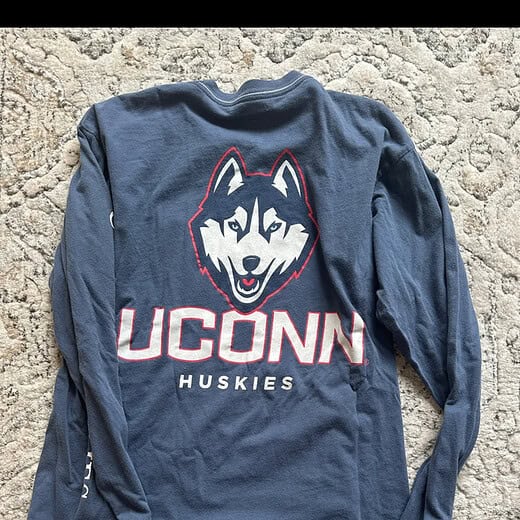 Back of UConn long-sleeve shirt featuring large Huskies graphic.