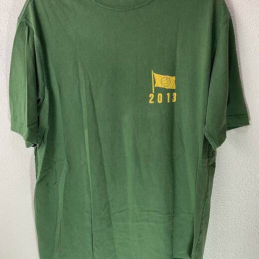 Front view of green 2013 Masters tee with small yellow chest logo and minimal branding
