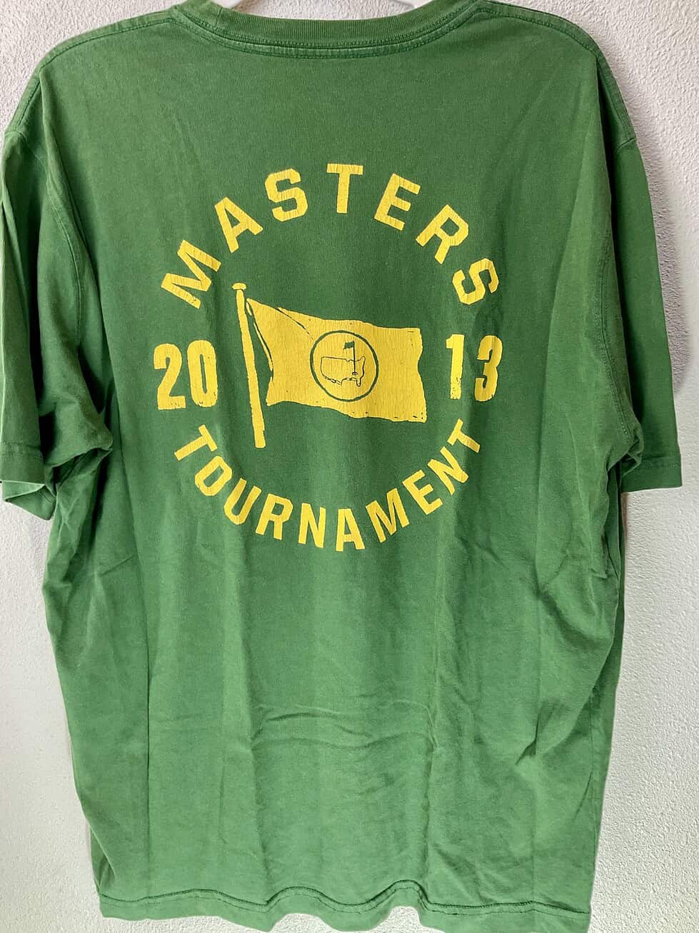Back of 2013 Masters Tournament green tee with distressed yellow flag and circular text graphic