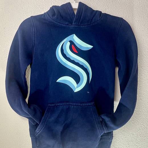 Seattle Kraken youth hoodie with official “S” logo in light blue and red