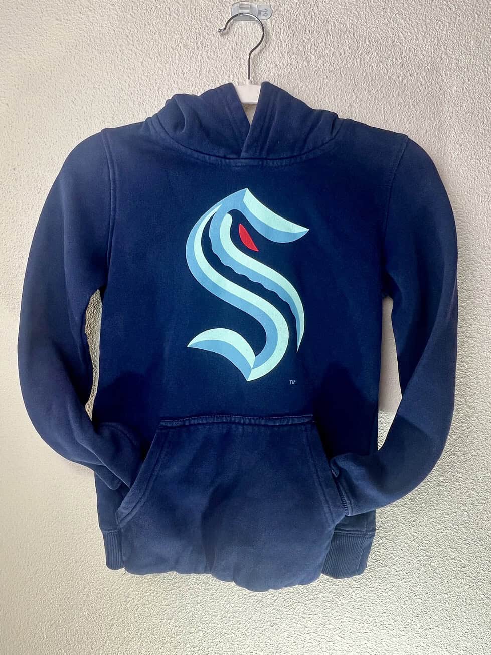 Seattle Kraken youth hoodie with official “S” logo in light blue and red
