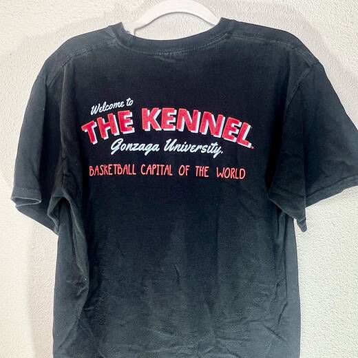 Back of Gonzaga t-shirt reading “Welcome to The Kennel – Basketball Capital of the World” in red and white print