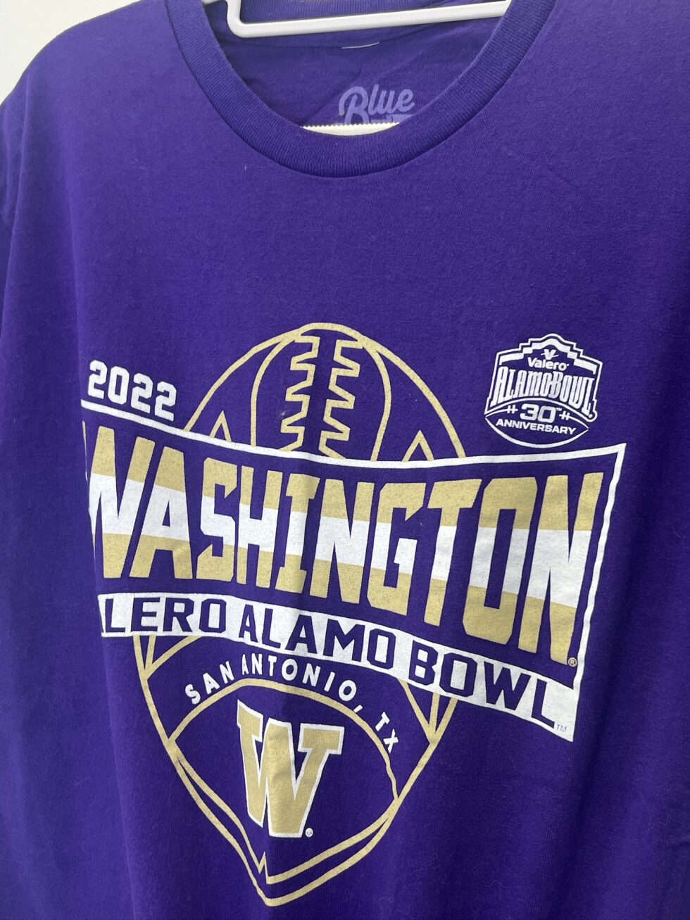 Close-up of football crest and Alamo Bowl 30th Anniversary logo on UW tee