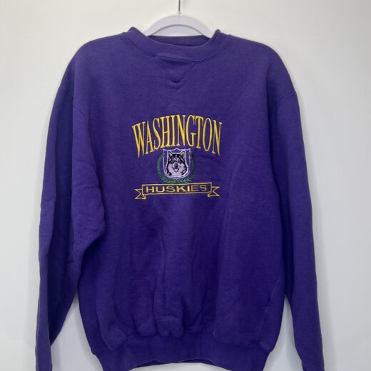 Front view of a vintage purple Washington Huskies Logo 7 crewneck sweatshirt with embroidered Husky graphic and text.