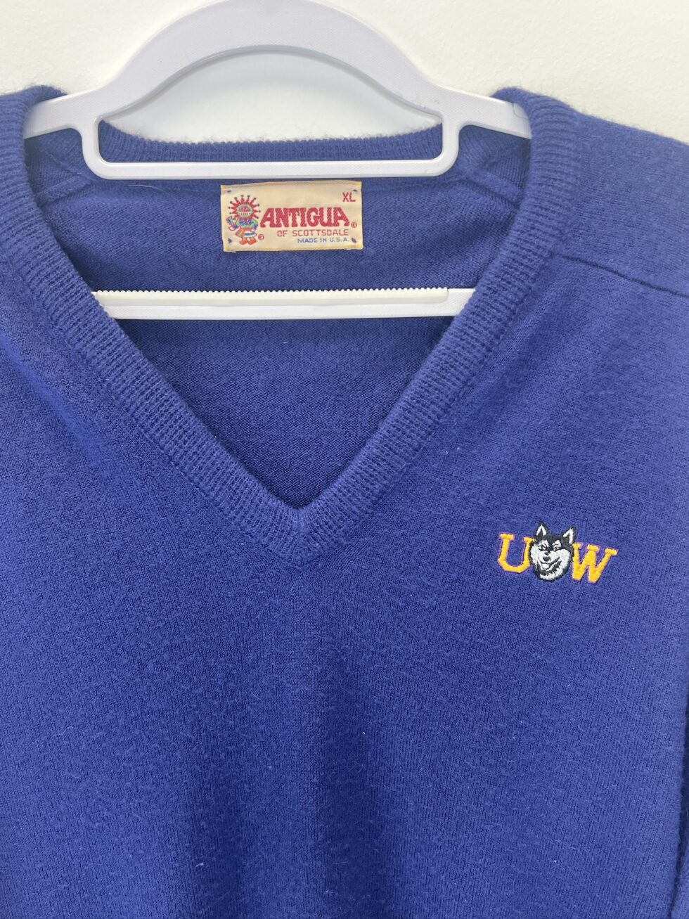 Close-up of 90s-style Antigua tag and Husky embroidery