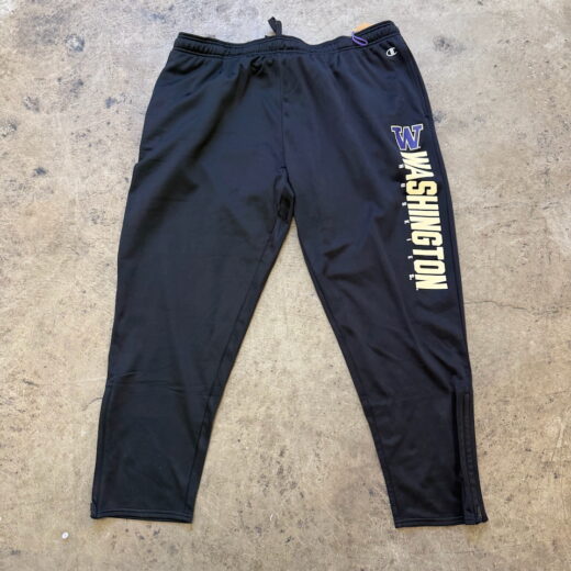 Front view of black Champion athletic pants in 2XL size, laid flat with tapered legs and elastic waistband.