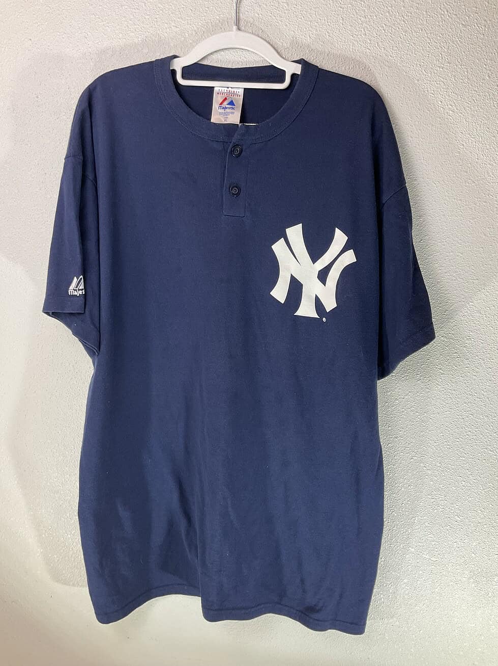 Front view of navy blue New York Yankees Majestic Henley T-shirt with white NY logo