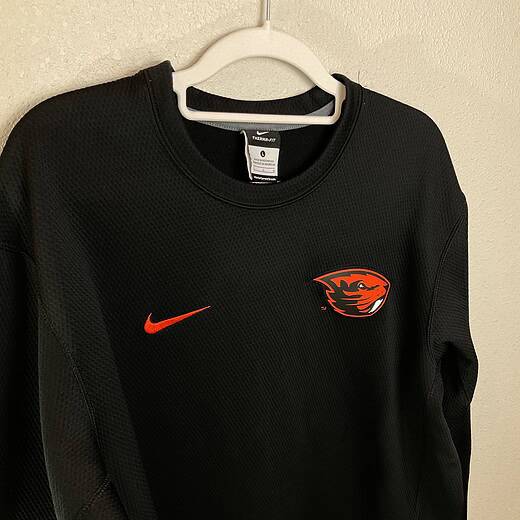 Front close-up of Oregon State Nike Therma-FIT sweatshirt with Beaver logo and Swoosh