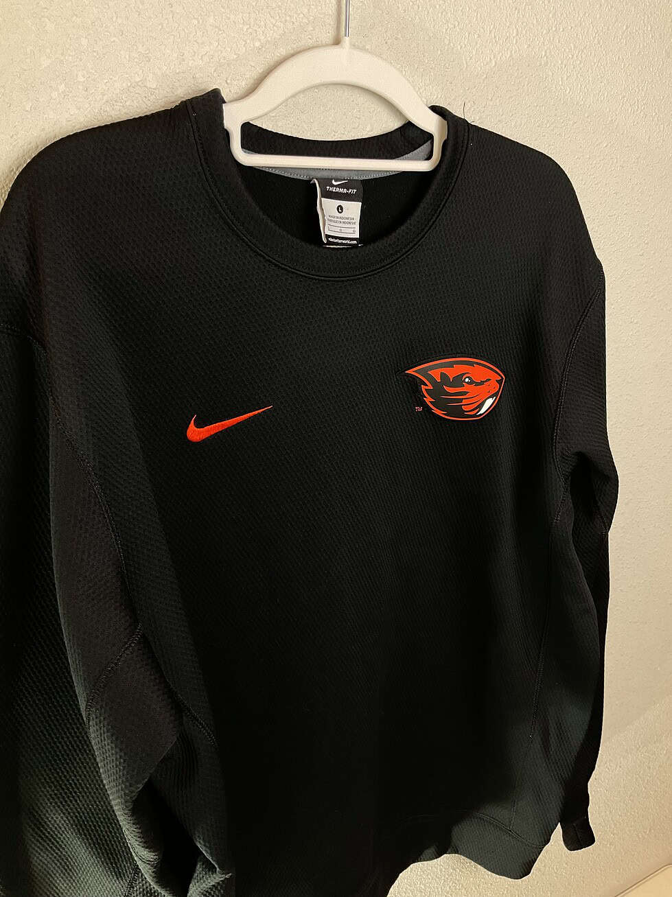 Front close-up of Oregon State Nike Therma-FIT sweatshirt with Beaver logo and Swoosh