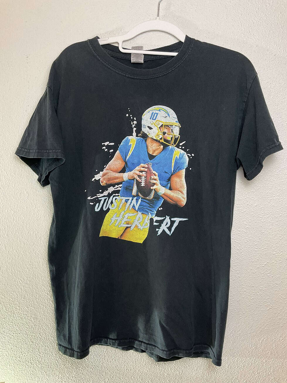 Full front view of black Gildan Justin Herbert T-shirt, size Medium, featuring Chargers graphic