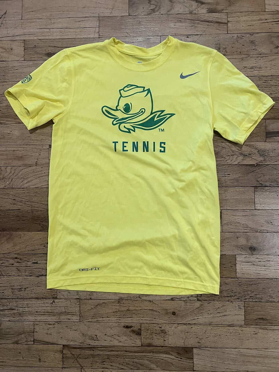 Classic yellow with green Duck logo and “TENNIS” text