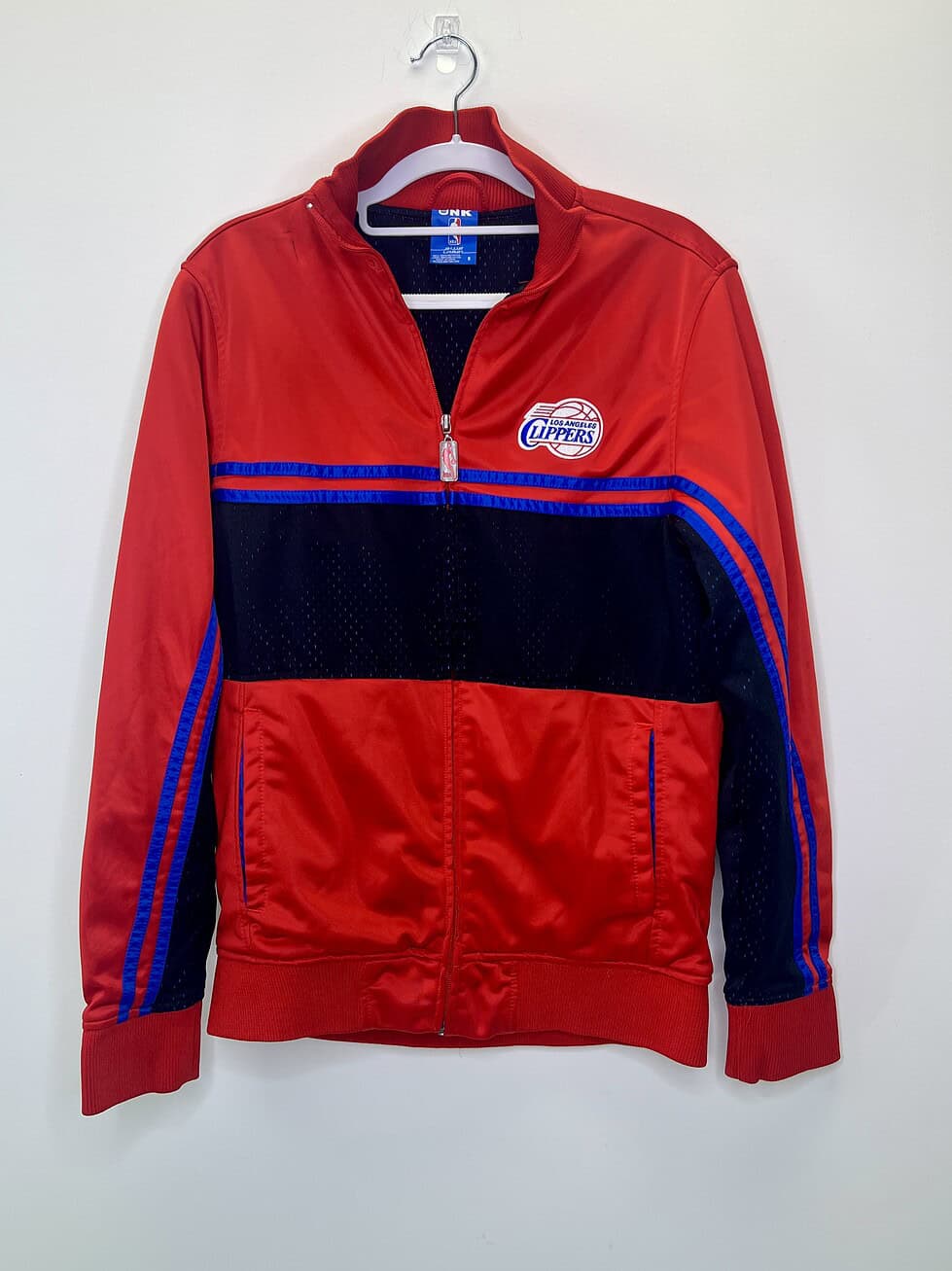 vintage-style Los Angeles Clippers red and black zip-up jacket with blue accents, NBA logo zipper pull, and mesh detailing.