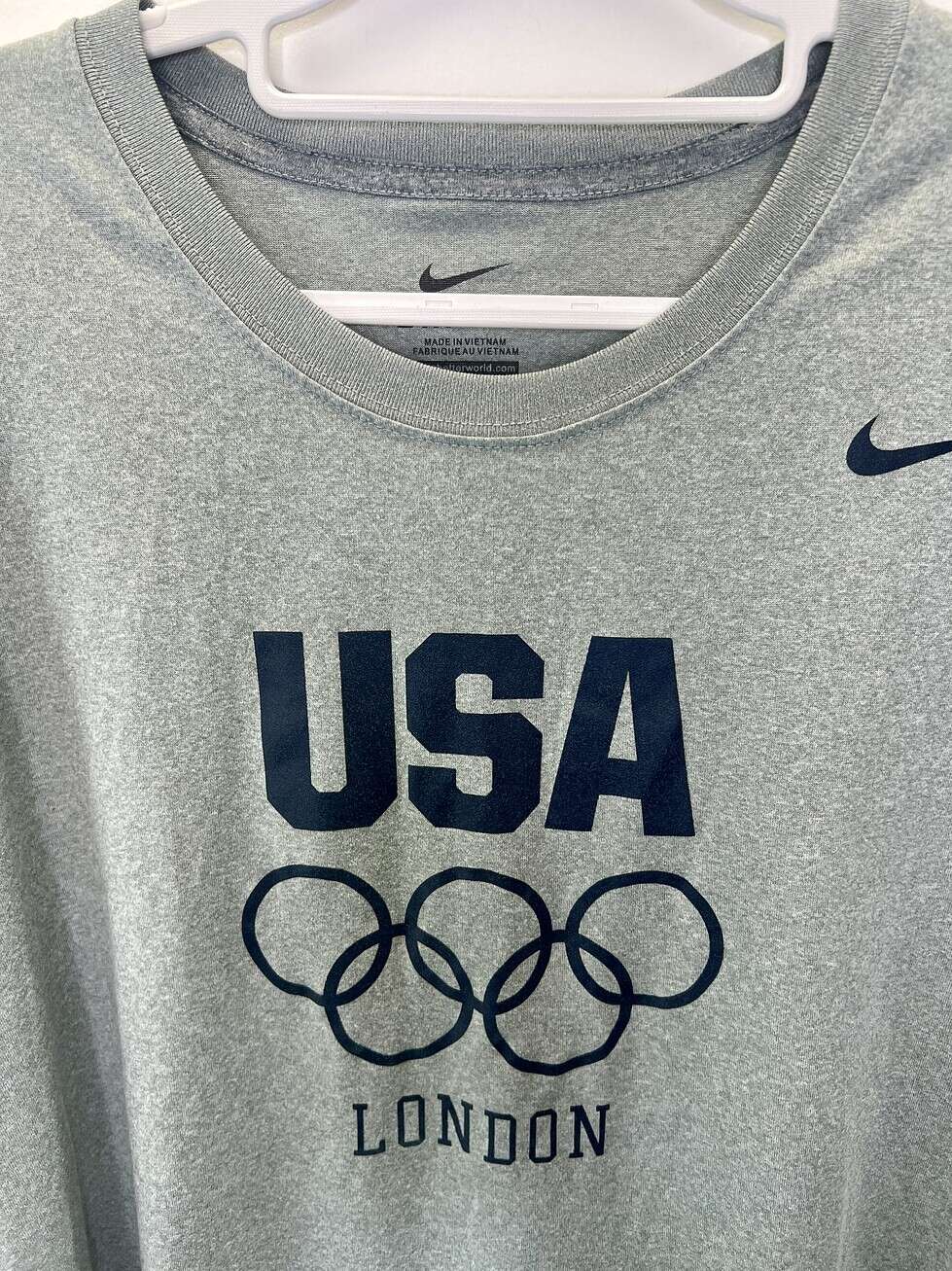 Gray Nike USA London Olympics T-shirt featuring Olympic rings and navy "USA" text, size XL.