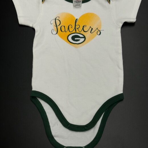 Front of Green Bay Packers baby onesie with gold heart and “Packers” text, size 6–12 months