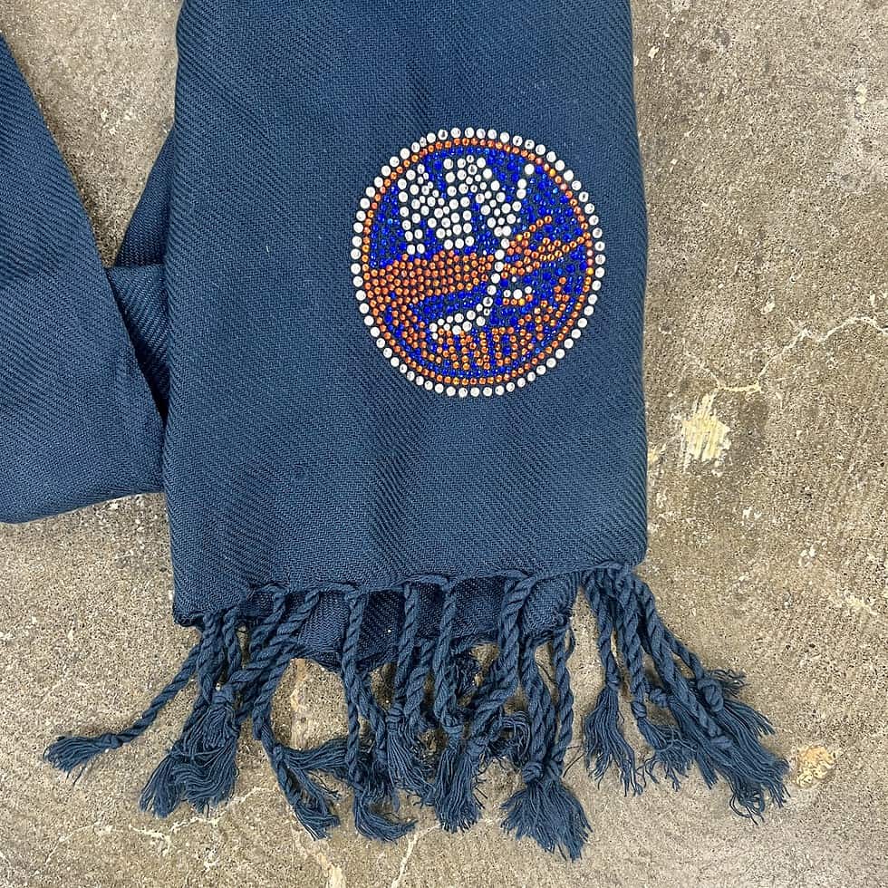 Navy blue scarf with bedazzled New York Islanders logo and fringe ends