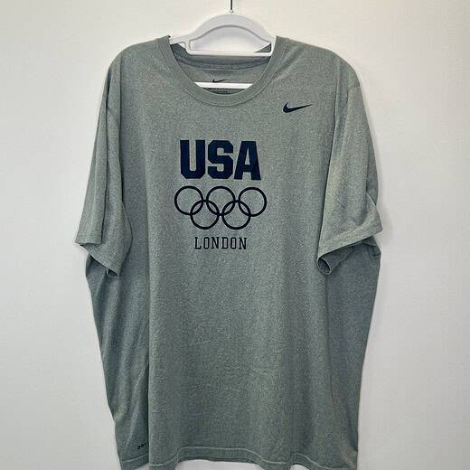 Gray Nike USA London Olympics T-shirt featuring Olympic rings and navy "USA" text, size XL.