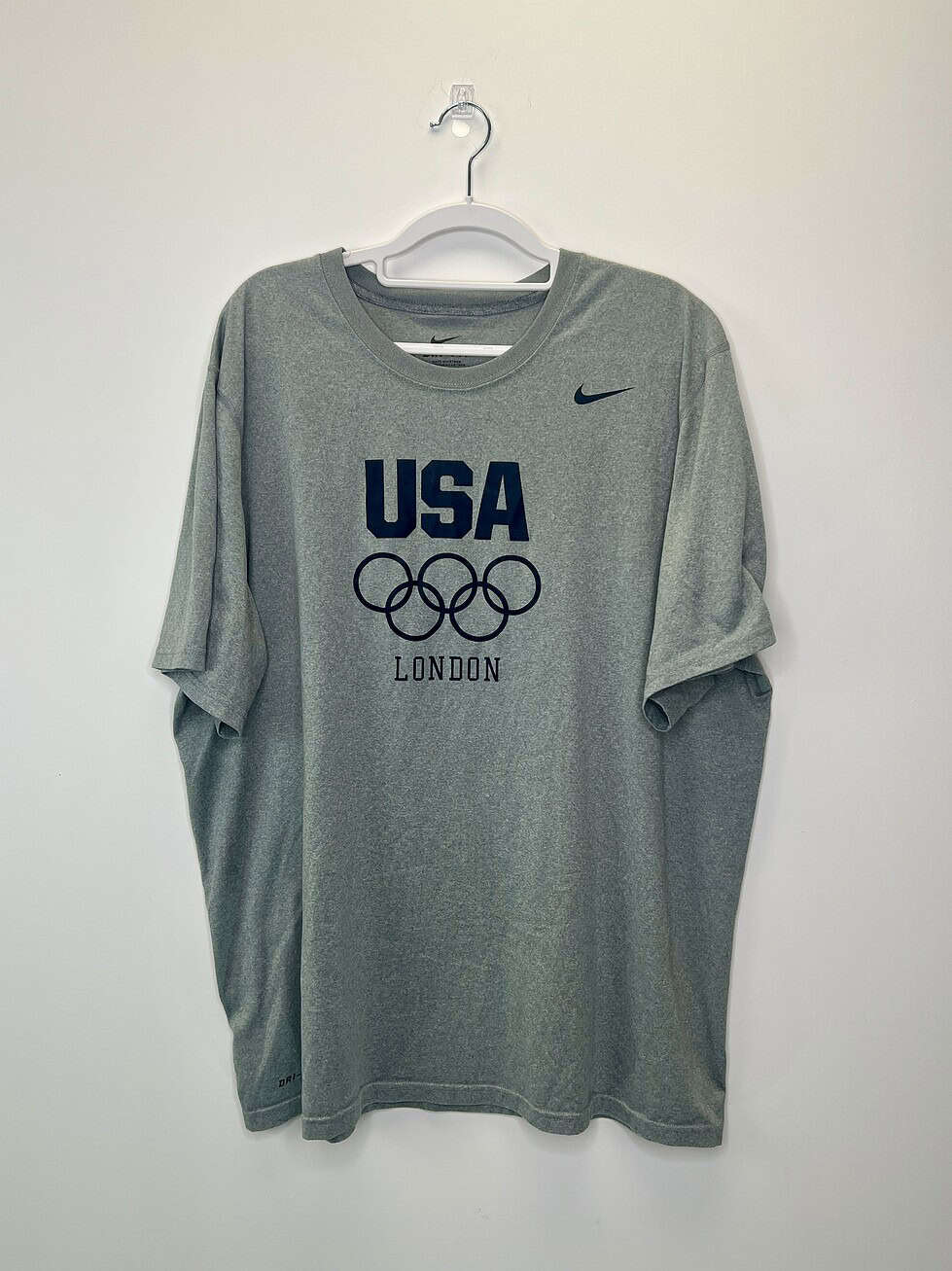 Gray Nike USA London Olympics T-shirt featuring Olympic rings and navy "USA" text, size XL.