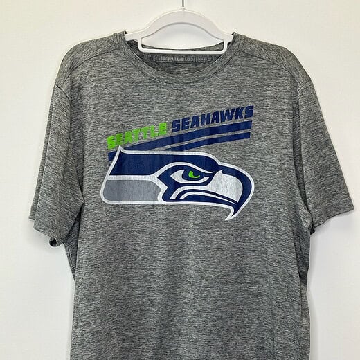Front view of heather gray Seattle Seahawks Majestic t-shirt with team logo and wordmark in XL size.